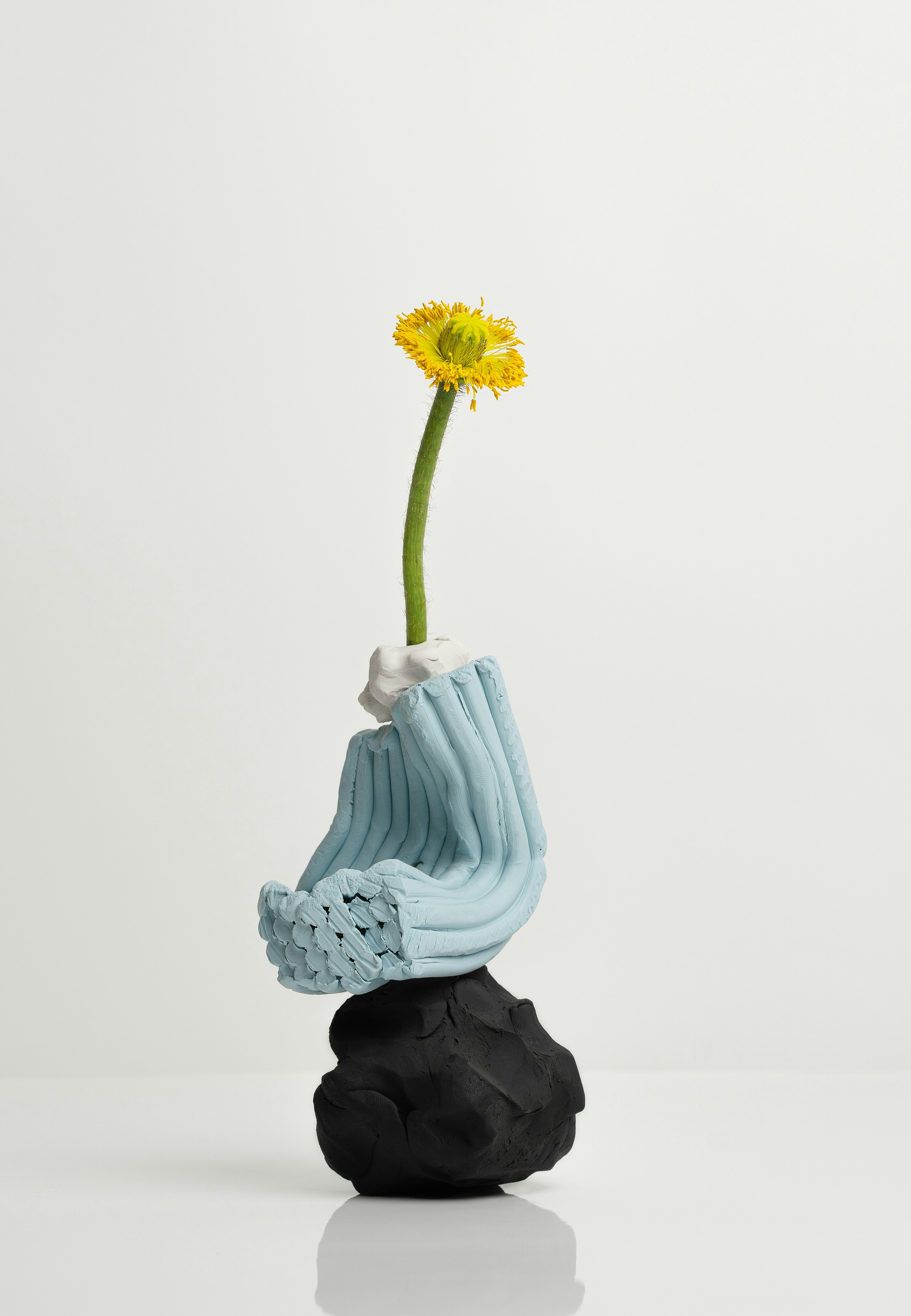 abstract sculpture with flower in vase